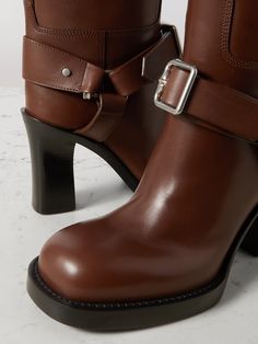 Find BURBERRY Le Stirrup Leather Boots on Editorialist. Burberry's 'Le Stirrup' knee boots are inspired by the label's equestrian heritage. Crafted from leather, they have buckled straps, chunky round toes and the house's archival logo embossed on the soles.