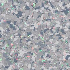 an abstract background with lots of small pieces of silver and green glitter on the surface