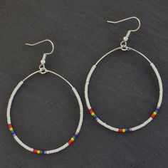 "Do you make these in silver?" After years of fielding that question about my best-selling Big Beaded Hoops, the answer is finally YES! Here you'll find all the classic styles — yes, even 'The Ones' — just reimagined with silver beads in place of gold. These dangle hoop earrings are the pieces you'll grab every day. beaded hoops with tiny glass seed beads silver-plated stainless steel ear wire hooks and beading wire lead-free and nickel-free comes with plastic earring back for security available Seed Bead Hoop Earrings, Bead Hoop Earrings, Plastic Earrings, Dangle Hoop Earrings, Chunky Beads, Rainbow Beads, Earring Cards, Beading Wire, Beaded Hoop Earrings