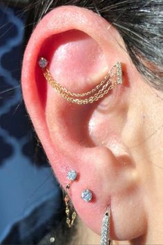 a close up of a person with ear piercings