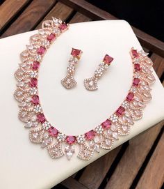 High quality 18kt Rose gold plated American diamond necklace studded with emerald cut color CZ stones. Luxury Diamond Kundan Necklace For Festive Occasions, Luxury Pink Bridal Necklace For Women, Luxury Pink Jewelry Sets For Festive Occasions, Luxury Pink Jewelry For Festive Occasions, Luxury Pink Jewelry Set For Celebration, Green And Pink Jewellery Set, Luxury Pink Temple Jewelry Necklaces, Rose Pink Necklace, Mint Green Jewelry