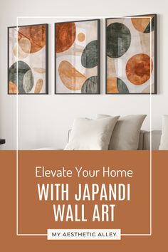 a living room with three paintings on the wall and text overlay that reads, elevate your home with japandi wall art