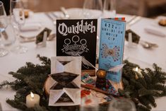 the table is set with candles, napkins and cards