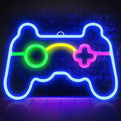 a neon video game controller is shown in the dark