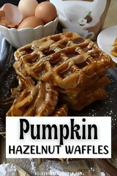 pumpkin hazelnut waffles on a plate with butter and eggs in the background