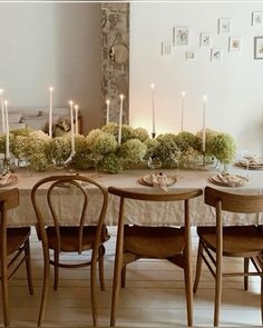 a dining room table with candles and flowers on it