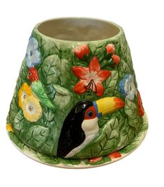 a ceramic vase with birds and flowers painted on it