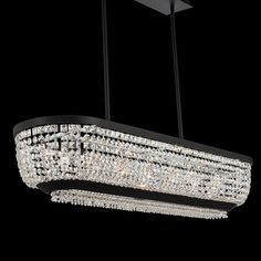 a large rectangular chandelier hanging from the ceiling in a dark room with black walls