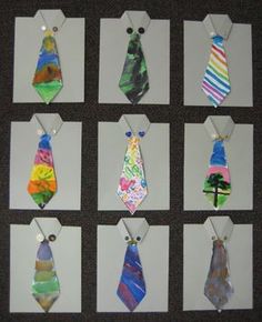 eight different colored ties hanging from tags on a wall in an art room or classroom