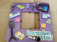 a purple photo frame with various items on it and a cd case in the middle