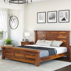 a bed room with a neatly made bed and pictures on the wall