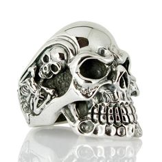 "Grandiose and imposing, make every outfit stand out with this gigantic sterling silver skull biker ring! With it's bold, menacing skull featuring a further two detailed skeletons on the side of the ring and its heavy 39 gram weight, this large, sterling silver ring is sure to grab attention. Produced with the utmost care at every stage and from the finest 100% solid sterling silver, you can be certain you're getting the very best in quality and a ring with the sturdiness and durability to last Rocker Rings, Rings Gothic, Sugar Skull Ring, Skeleton Ring, Sterling Silver Skull Rings, Hammered Silver Jewelry, Mens Skull Rings, Silver Skull Ring, Biker Jewelry