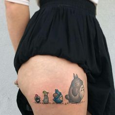 a woman's thigh with an image of the characters from winnie the pooh on it