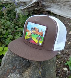 In the desert, magic is everywhere and Henry finds it for you with wonderful painting reproduced on this trucker hat. Featuring a flat bill and one size fits most, this mesh back snap back cap is for you. Fits even most larger head sizes. Cheap Urban Flat Bill Hats, Summer Flat Bill Snapback Hat, Gold Leaf Bill Hat, Desert Magic, White Trucker Hat, Snap Back Cap, Country Hats, Flat Bill Hats, In The Desert