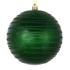 a green christmas ball ornament hanging from a gold chain on a white background