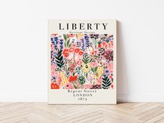 the book liberty is sitting on top of a wooden floor next to a white wall