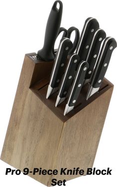 a set of knives sitting on top of a wooden block with the words pro - 9 piece knife block set