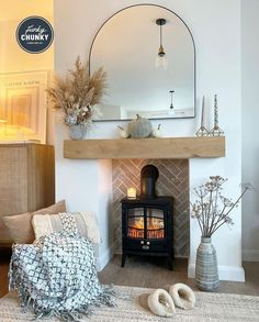 a living room filled with furniture and a fire place next to a mirror on the wall