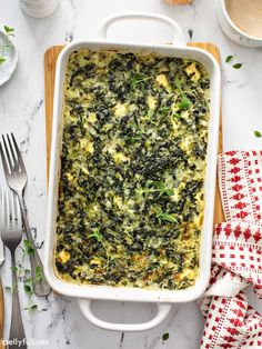 a casserole dish filled with spinach and cheese