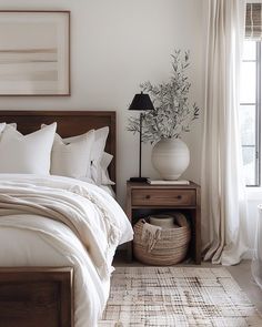 a bedroom with white linens and neutral decor