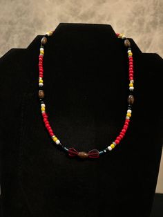 17 inch lightweight choker-style red theme beaded necklace. Native inspired and made. Red Beaded Necklaces As A Gift, Burgundy Beaded Necklaces With Round Beads As Gift, Handmade Adjustable Red Choker, Adjustable Handmade Red Choker, Red Beaded Chain For Festivals, Red Beaded Choker With Large Beads, Red Large Beads Choker Necklace, Red Wooden Beaded Necklaces, Adjustable Red Necklace With Colorful Beads