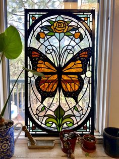 a stained glass window with a yellow butterfly on it