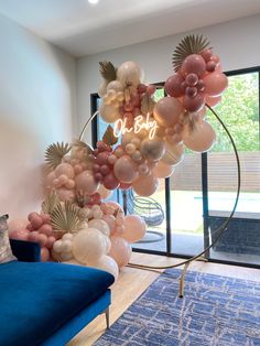 the balloon arch is decorated with pink and white balloons