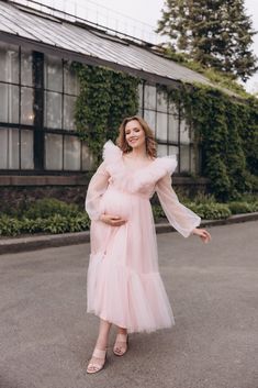 Tulle maternity dress for photo shoot with a translucent V-neckline in the front and back, which is decorated with two layers of ruffles. An additional row of ruffles is sewn at the bottom to give the skirt splendor. Voluminous puff sleeves on the cuffs, which we sewed from elastic mesh. The dress has a drawstring at the back to adjust the size to ensure a perfect fit. The back is decorated with a hidden zipper and lacing, which helps you adjust the size of the dress! MADE TO ORDER The dress we Elegant Maternity Dress With Ruffles For Wedding, Pink Maternity Dress With Ruffles, Spring Maternity Gown With Ruffles, Pink Ruffled Maternity Maxi Dress, Pink Ruffled Maxi Dress For Maternity, Elegant Pink Tulle Maternity Dress, Wedding Maternity Dress With Ruffles, Pink Ruffled Maternity Dress, Maternity V-neck Dress With Ruffles