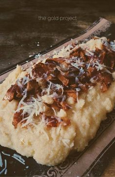 a piece of bread with cheese and nuts on it