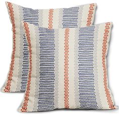 two pillows with red, white and blue designs on them sitting next to each other