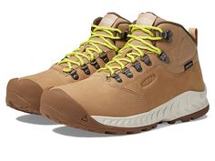 a pair of brown hiking boots with yellow laces