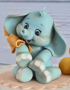 an elephant figurine sitting on top of a cake