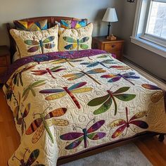 a bed with dragonflies on it in a room next to a lamp and window