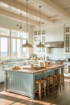 a large kitchen with an island in the middle and two stools at the end