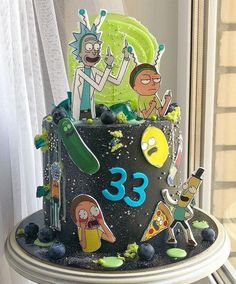 a birthday cake decorated with cartoon characters on it's side and numbers in the middle