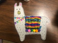 a llama made out of yarn sitting on top of a table