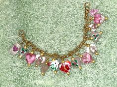 "ON SALE Unique and ONE OF A KIND, this lovely, handmade ALL HEART CHARM bracelet is a delight. At 7 1/2\" in length, this beauty starts with a shiny, gold-filled ROLO chain. There is a stunning gold pocket watch clasp. The 12 artisan glass charms are all in \"shades of pink,\" and all offer different and lovely appearances. The two charms that are not made of glass are a rectangular GOLD RHODIUM charm with micro pave background and a fuchsia micro pave heart in the middle and a hanging gold rho Handmade Cute Heart Bracelet, Heart Beads Jewelry For Valentine's Day Crafting, Vintage Heart Charm Bracelet For Valentine's Day, Handmade Heart Charm Bracelet For Mother's Day, Cute Handmade Heart Charm Bracelet, Valentine's Day Heart Beads Jewelry For Crafting, Vintage Heart Charm Bracelet With Lobster Clasp, Vintage Bracelets With Heart Beads For Gift, Vintage Heart Bracelet With Charm For Valentine's Day