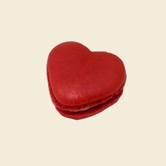 a red heart shaped cookie sitting on top of a table