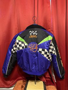 Vintage Arctic Cat Jacket  - Rare  - 90's vintage  - Inner liner zip out  - 2/1 jacket  - Neon  - Team Arctic Cat Racing  - Checkered Flag design  - Big Cat back logo  Size: XL  28" shoulder to waist  26" armpit to armpit  Good vintage condition  No rips or holes  No stains  Storage wear only Cat Jacket, Cat Races, Tokyo Aesthetic, Neo Tokyo, Checkered Flag, Racing Jacket, Big Cat, Snowmobile, Flag Design