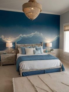 a bedroom decorated in blue and white with a large painting on the wall