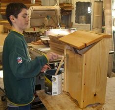 a young man working on a piece of wood