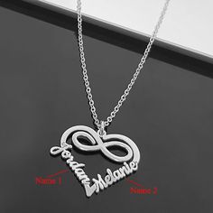 Heart-Shaped Double Name Necklace, Crafted with exquisite attention to detail, the heart-shaped pendant features two elegantly engraved names, representing the unique relationship between you and your loved one. The names are delicately intertwined, reflecting the intertwining of your lives and the love that binds you together. A beautiful and meaningful piece of jewelry that symbolizes the connection between two individuals. This necklace is the perfect gift for Valentine's Day, allowing you to express your love and celebrate your special bond. Valentine's Day Double Heart Custom Name Necklace, Custom Name Infinity Necklace For Valentine's Day, Heart-shaped Name Necklace For Valentine's Anniversary Gift, Valentine's Day Heart Pendant Name Necklace With Adjustable Chain, Cheap Heart-shaped Name Necklace For Valentine's Day, Valentines Day Gifts For Her, Valentines Necklace, Name Necklace, Ring Bracelet