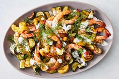 a plate filled with shrimp and vegetables on top of a table