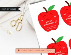 a pair of scissors sitting on top of an apple shaped card with the words you are awesome