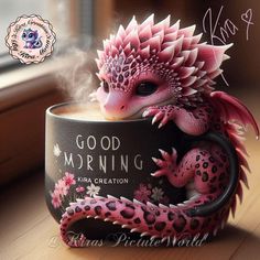 a pink and black dragon sitting in a cup with the words good morning written on it