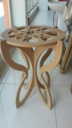 a wooden table sitting on top of a white tiled floor next to a window sill