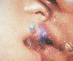 a close up of a person's nose with different colored balls on it and stars in the background