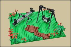 a lego model of a park with swings and flowers