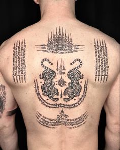 the back of a man with tattoos on his upper and lower body, showing intricate designs