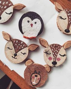 four handmade deer and bear magnets sitting on top of a table